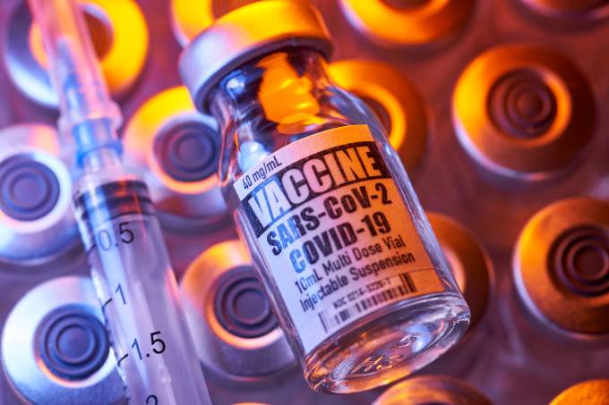Covid-19 vaccine - Medical injection vials: syringe with close-up and colorful (Bill Oxford/Getty Images)